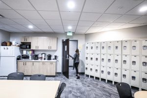 Student lounge with lockers on right wall. Lower and upper cabinets are in background. 